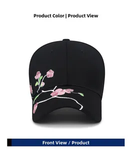 Close-up of intricate pink plum blossom embroidery on a black cotton baseball cap