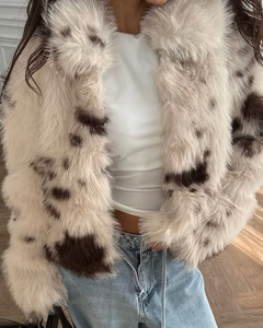 Detail shot of the plush faux fur texture on this stylish spotted short coat for women