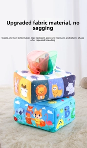 Detail of plush tissue box toy with colorful sensory scarves and cartoon animal prints