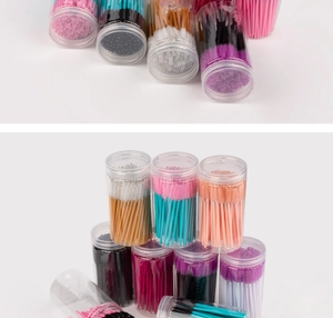 Close-up of disposable colorful eyelash brushes in transparent protective tubes