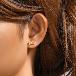Detailed view of a gold crown stud earring with three marquise-cut marquise-cut zircons