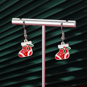 Detail of Christmas stocking drop earrings with red and green enamel on a silver hook