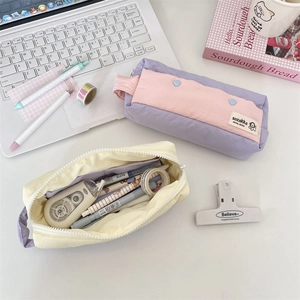 Macro shot of large capacity pastel stationery pouches showing internal storage and fabric detail