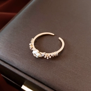 Detailed close-up of 14K gold plated flower ring with pearl and sparkling crystals