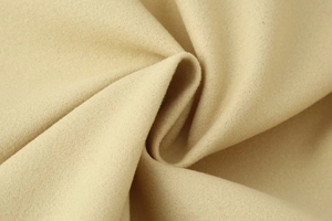 Detailed macro view showing the soft wool texture and fine fibers of the beige woolen jacket