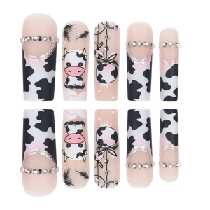 Extra long coffin press-on nails featuring pink tones, cow prints, and rhinestone accents
