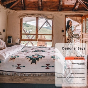 Detail of bohemian knit throw blanket with geometric patterns and tassels in a luxury tent
