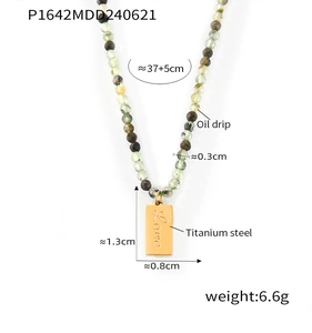 Detail showing the adjustable chain length and titanium steel Love tag on beaded necklace