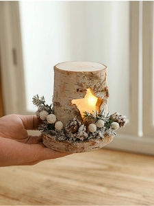 Close-up of wooden star lamp with pine cones and warm LED light through cutouts