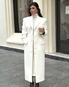 Detail of white long wool coat with notched lapel and structured waist design