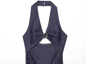 Detail of navy blue denim halter dress featuring cutout design and metallic hardware rings