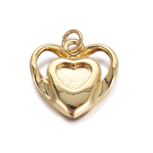 Detail of a gold heart pendant with a portrait relief for jewelry making