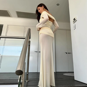 Detail of off-white off-shoulder dress with long sleeves and pleated mesh texture