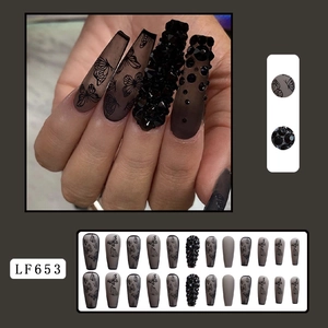 Detail of matte black coffin nails with butterfly patterns and rhinestones model LF653