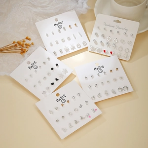 Flat lay of five fashion earring sets with gold and silver geometric heart designs