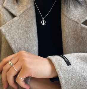 Close-up of S925 sterling silver heart pendant necklace and layered silver ring set