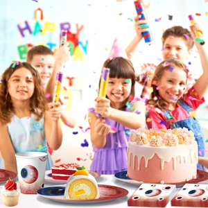 Close-up of spooky eye-themed party tableware set including paper plates, cups and napkins