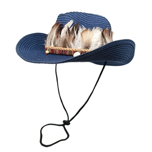 Detail of blue woven straw cowboy hat featuring natural feathers and ethnic band