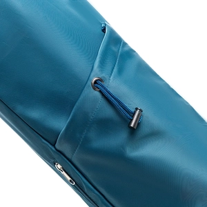 Detail of teal yoga bag with drawstring closure and metal eyelet on waterproof fabric
