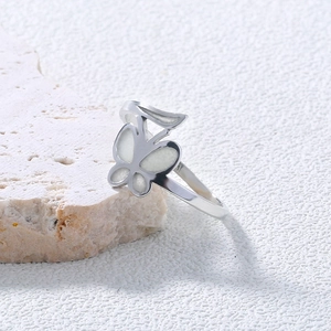 Detailed view of silver butterfly heart ring on raw white stone for Halloween gift