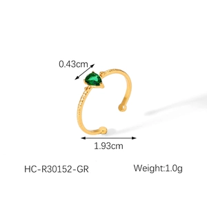 Detail showing an 18k gold plated ring with a pear-cut green zircon and hammered texture