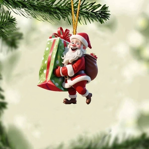 Detail of 3D Santa Claus ornament with green gift bag hanging on a Christmas tree branch