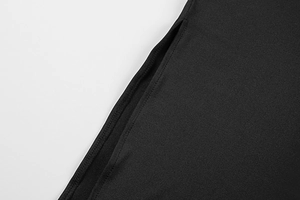 Macro detail of high-quality black pleated fabric sewing and side slit on an elegant dress
