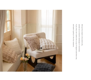 Detail of soft faux rabbit fur throw pillow with chic striped texture on cozy white sofa