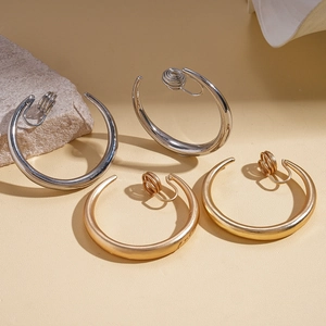 Minimalist geometric round clip-on earrings in gold and silver metal finishes on stones