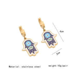 Detail view of Hamsa hand earrings in stainless steel with colorful enamel and rhinestones