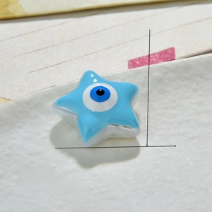 Macro view of 13mm light blue star-shaped resin Evil Eye beads for DIY jewelry making