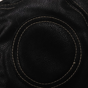 Macro detail of the reinforced double-circle stitching on durable black leather winter hat