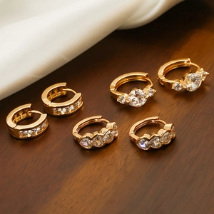 Three pairs of 925 sterling silver gold plated hoop earrings with sparkling cubic zirconia