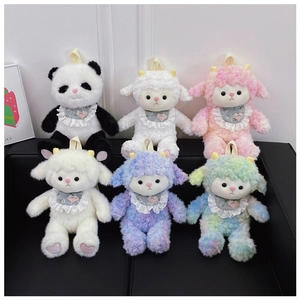 Detailed macro of assorted plush panda and sheep dolls with lace bibs and soft texture