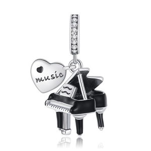 Detailed view of silver music charm with heart tag and black piano pendant for bracelets