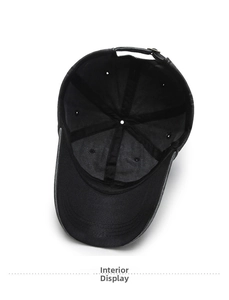 Internal detail of a black vintage denim baseball cap showing six-panel seams and metal buckle