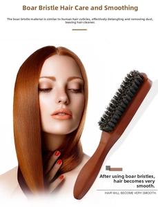 Detail of natural boar bristle hairbrush on smooth brown hair with wooden handle