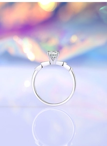 Macro detail of 925 sterling silver ring with 5mm moissanite diamond in four-prong setting