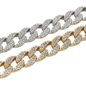 Close-up of gold and silver cuban necklaces with high-quality sparkling rhinestones