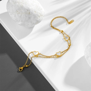 Double-layered golden stainless steel heart bracelet with white mother-of-pearl inlays