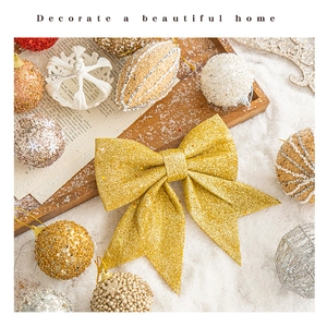 Close-up of champagne gold glitter bow ornament for Christmas tree festive decoration