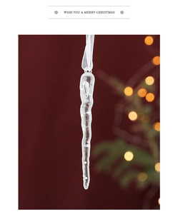Close-up of clear acrylic icicle Christmas tree hanging ornament with bokeh lighting