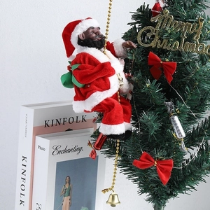 Detail of a Black Santa Claus climbing a gold bead chain on a decorated Christmas tree