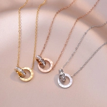 Detail of interlocking ring pendants with Roman numerals and pavé crystals on silk
