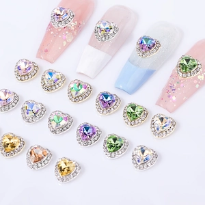 Detailed macro view of heart-shaped crystal nail charms in various aurora colors