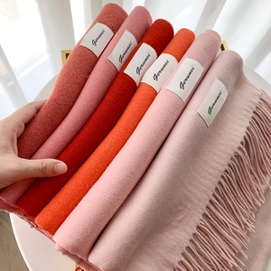 Thick solid color cashmere scarves with fringe details in multiple warm autumn colors