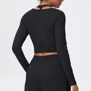 Detail view of the seamless back stitching on a black V-neck long sleeve yoga set