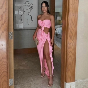 Detailed close-up of pink strapless top with 3D rose and slit maxi skirt with ruffles