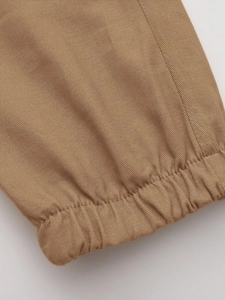 Detail of khaki cotton twill fabric showing quality stitching and elastic cuffs