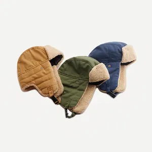Three-color set of fleece-lined trapper hats in yellow, green, and navy blue for winter warmth